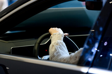 close-up of a man sitting behind the wheel of a new car