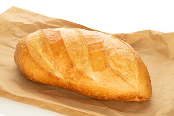 One wheat bun, close-up, isolated on a white background.
