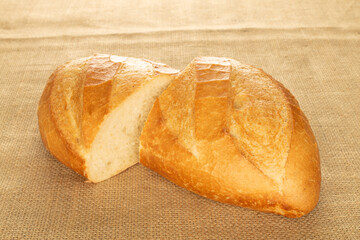 One wheat bun on a jute cloth, close-up.