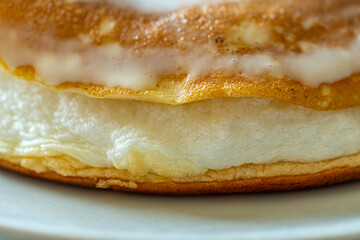 Slice of omelette poulard with pancakes on a light background. close-up