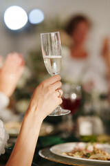 without a face. A bride at the table of the newlyweds with a glass of champagne