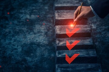 Hand with pen ticks glowing checkmarks on steps.