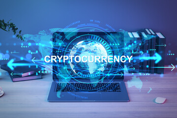 Cryptocurrency concept with digital globe and data elements on laptop screen in office setting on wooden desk with books and mouse in background.