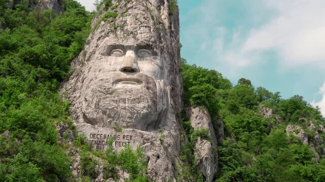 Decebal's (Decebal Rex)face carved into the rock seen from the Danube, 4k