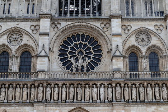 Paris, France-April 16, 2025: Rose Window and Statues of Notre-Dame