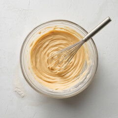 Mixing ingredients in glass bowl with whisk: creating smooth batter for baking