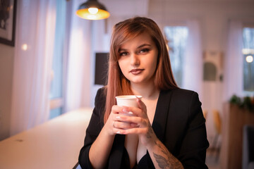 Portrait of a beautiful red-haired girl in a dark jacket.