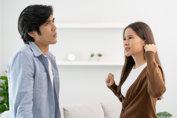 Family problems, Asian couple quarrel together at home. woman angry on man and man feel annoy.