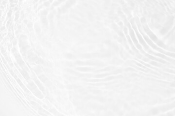 White water with ripples on the surface. Defocus blurred transparent white colored clear calm water surface texture with splashes and bubbles. Water waves with shining pattern texture background.
