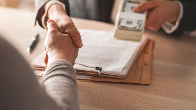 Shaking hands and receiving banknote