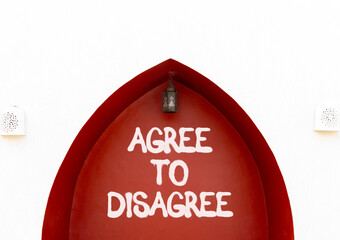 Agree to disagree symbol. Concept words Agree to disagree on beautiful white and red wall....