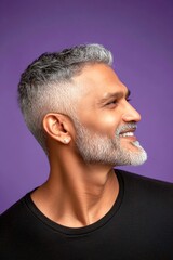 Fototapeta premium Conceptual art of style for aging men. Trendy men's low fade haircut - midlife indian man with short hair. A serene and handsome man posing in style. Purple solid background.