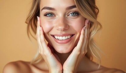 Young woman with glowing healthy skin holds hands on face in contemplative pose, showcasing natural beauty and radiant complexion with soft lighting and neutral background