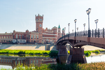 Beautiful cast iron bridge against the backdrop of the Republican Puppet Theater in Yoshkar-Ola....