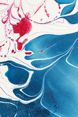 Abstract background of marbled paper in predominantly blue colors 
