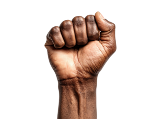 Close-up studio shot of a clenched fist with a black background emphasizing strength and determination