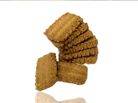 Caramel brown tasty Biscuits isolated on white background .Crispy Biscuits artistically arranged on the white background