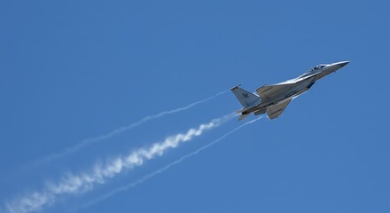 Aircraft Flying in Blue Sky Leaving Vapor Trails
