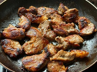 Fried meat in a frying pan