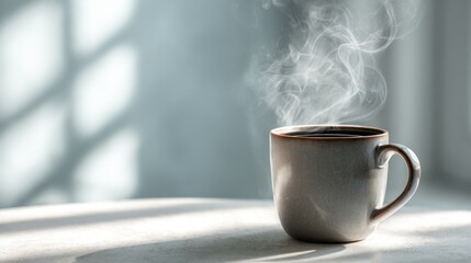 Steaming cup of coffee on a sunlit table