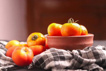 Fresh red tamotoes with kitchen cloth and kept in a bowl, healthy vegetable in the kitchen