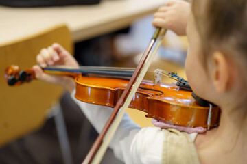 Young musician practices violin in a classroom during music lesson after school © andov