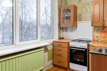 the old furniture in the kitchen is not repaired. kitchen with upper and lower cabinets, gas stove....