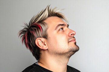 Fototapeta premium Modish men's colored rebellious haircut - midlife white man with blond hair. Pure white solid background. An elegant midlife gentleman smiling gracefully. Idea of style for aging men.