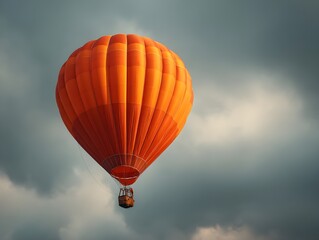 Fototapeta premium Soar With an Orange Hot Air Balloon Against a Majestic Cloudy Sky For Serene Flight