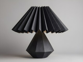 Enhance interiors with charcoal reinforced paper lampshade featuring folded architecture design and ambient light diffusion