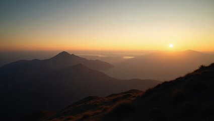 Fototapeta premium Majestic Sunset Over Mountain Ranges With Distant Peaks Illuminated in Warm Golden Hues, Creating a Tranquil Atmosphere in the Evening Sky