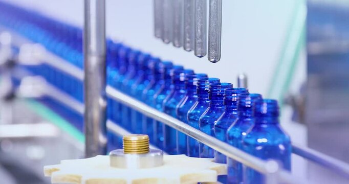 Pharmaceutical manufacturing line for liquid medicine production, automatic bottle filling machine for syrup, sanitizer, or gel in plastic bottles at sterile industrial packaging facility