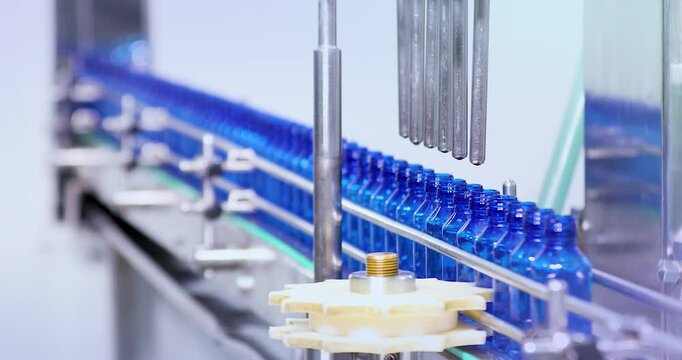 Pharmaceutical manufacturing line for liquid medicine production, automatic bottle filling machine for syrup, sanitizer, or gel in plastic bottles at sterile industrial packaging facility