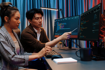 IT developers discussing with point to intelligent website development coder system running data...