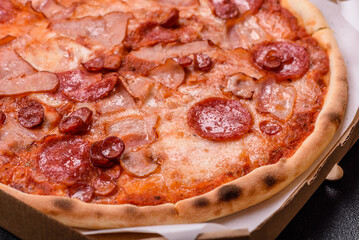 Italian pepperoni pizza with cheese and salami, tomatoes and sauce