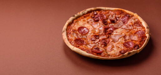 Italian pepperoni pizza with cheese and salami, tomatoes and sauce