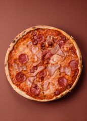 Italian pepperoni pizza with cheese and salami, tomatoes and sauce