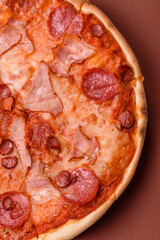 Italian pepperoni pizza with cheese and salami, tomatoes and sauce