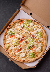 Italian caesar pizza with cheese and chicken, lettuce leaves and sauce