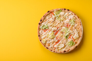 Italian caesar pizza with cheese and chicken, lettuce leaves and sauce