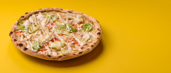 Italian caesar pizza with cheese and chicken, lettuce leaves and sauce