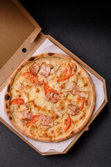 Italian pizza with chicken and bacon, cheese, tomatoes and sauce