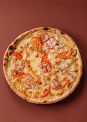 Italian pizza with chicken and bacon, cheese, tomatoes and sauce