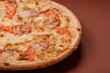 Italian pizza with chicken and bacon, cheese, tomatoes and sauce