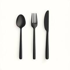 Minimalist Flat Lay of Black Cutlery: Spoon, Fork, and Knife on a Clean White Surface.