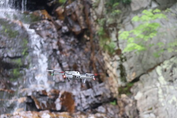 Drone flying over a waterfall.