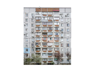 Nine-storey apartment building with enclosed balconies and air conditioning units is isolated. 1980s residential prefabricated building with tiled facade and satellite dishes. © Dmytro