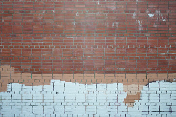 Brick wall painted with stripes of paint.