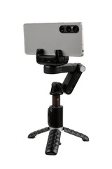 Smartphone mounted in horizontal orientation on compact gimbal stabilizer tripod, isolated on white back