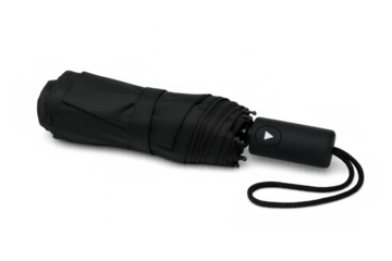 Folded black umbrella with wrist strap lying on transparent background, ready for rain or bad weather